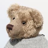 Bosworth is a solid and distinguished one of a kind, traditional, mohair artist teddy bear by Barbara Ann Bears, he stands 17 inches (43cm) tall and is 12 inches (31cm) sitting and made from fairly long, slightly wavy greyish-brown brown mohair with a hint of green, he has beige wool felt paw pads and hand painted eyes and wears a hand knitted jumper