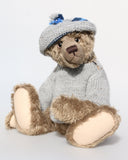 Bosworth is a solid and distinguished one of a kind, traditional, mohair artist teddy bear by Barbara Ann Bears, he stands 17 inches (43cm) tall and is 12 inches (31cm) sitting and made from fairly long, slightly wavy greyish-brown brown mohair with a hint of green, he has beige wool felt paw pads and hand painted eyes and wears a hand knitted jumper and hat