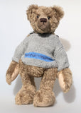 Bosworth is a solid and distinguished one of a kind, traditional, mohair artist teddy bear by Barbara Ann Bears, he stands 17 inches (43cm) tall and is 12 inches (31cm) sitting and made from fairly long, slightly wavy greyish-brown brown mohair with a hint of green, he has beige wool felt paw pads and hand painted eyes and wears a hand knitted jumper