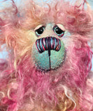 Bramble is a sweet and very cheerful, one of a kind artist bear, in hand dyed mohair by Barbara-Ann Bears Bramble stands 10 inches( 25 cm) tall and is 7.5 inches (19 cm) sitting. Bramble is a beautifully coloured and very happy teddy bear who is also wonderfully fluffy, he isn't a bear to dazzle but he is full of love and cuddles.