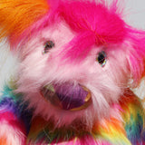 Her head is a long, soft baby pink faux fur, the backs of her ears and her tummy band are a very long and soft magenta faux fur, the fronts of her ears are an even longer orange faux fur and the top of her head and the tip of her tail are a very long vivid magenta faux fur, she's a very colourful cow and very proud of it. Britney has very big beautiful, hand painted eyes and a splendid intricately sewn form multi-coloured printed cotton fabric to compliment her colouring