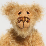 Brodie is a very sweet and friendly artist bear in wildly curly mohair by Barbara-Ann Bears, he stands 8.5 inches/21 tall and is 6 inches 15 cm sitting.  Brodie is made from curly beige gold mohair with brown wool felt paws, he has hand painted glass eyes with eyelids, a carefully embroidered nose and a beaming smile