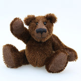 Bruce McCubbin is made from a short, stubbly (plain chocolate) brown mohair, perfect mohair for a proper little bear. Bruce's paw pads are made from the same mohair, trimmed down to the finest stubble.  Bruce McCubbin has small spherical glass eyes, that catch the light whichever way you look at him, he has a pert little nose embroidered from fine black perle cotton and a beaming smile