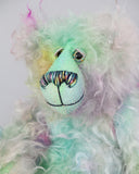 Bryn Bryn Bruin is made from one beautiful piece of hand dyed mohair, a long and fluffy, tousled mohair hand dyed with splashes of pastel colours, turquoise, jade, pale blue, soft pink, amber, green, gold, magenta and lilac. He has hand dyed velvet paw pads. Bryn's beautiful eyes were hand painted to match his mohair as were his hand coloured eyelids. His nose was embroidered with individual threads to match his colouring and he has a sweet and cheerful smile