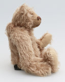 Buster is a very sweet and friendly, quite traditional, one of a kind, mohair artist teddy bear by Barbara Ann Bears, he stands 10 inches/25 cm tall and is 7.5 inches/19 cm sitting. Buster is made from beautiful, quite sparse, fairly straight, soft beige mohair, with German wool-felt paw pads and spherical, glass eyes