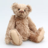 Buster is a very sweet and friendly, quite traditional, one of a kind, mohair artist teddy bear by Barbara Ann Bears, he stands 10 inches/25 cm tall and is 7.5 inches/19 cm sitting. Buster is made from beautiful, quite sparse, fairly straight, soft beige mohair, with German wool-felt paw pads and spherical, glass eyes