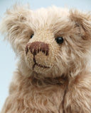 Buster is a very sweet and friendly, quite traditional, one of a kind, mohair artist teddy bear by Barbara Ann Bears, he stands 10 inches/25 cm tall and is 7.5 inches/19 cm sitting. Buster is made from beautiful, quite sparse, fairly straight, soft beige mohair, with German wool-felt paw pads and spherical, glass eyes