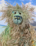Byron is a wild thing, yet a very friendly wild thing, a one of a kind, hand dyed mohair artist bear by Barbara-Ann Bears, he stands 10.5 inches (26 cm) tall and is 8 inches (20 cm) sitting. He is made from a gorgeous, long, straggly mohair that Barbara has dyed in jade, turquoise with some green, amber and sky blue
