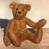 Charleston is a charming, traditional one of a kind artist bear in German mohair by Barbara Ann Bears, he stands 10 inches/27 cm tall and is 7.5 inches/22 cm sitting. Ambrose is made from wildly distressed, 'proper brown' German mohair, he has matching brown, wool-felt paw pads and vintage boot buttons for eyes