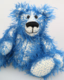 Charlie McCubbin is made from a sparse, stringy blue mohair that has a pale, almost white, cotton backcloth, giving him a charmingly fluffy, scruffy appearance. Charlie's paw pads are made from the same mohair, trimmed down to the finest stubble.  Charlie McCubbin has small spherical glass eyes, that catch the light whichever way you look at him, he has a pert little nose embroidered from fine black perle cotton and a beaming smile