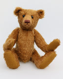 Cinnamon is an elegant and charming, one of a kind, traditional artist teddy bear by Barbara Ann Bears, he stands 15.5 inches/39cm tall and is 11 inches/28 cm sitting. Cinnamon is made from fairly sparse and wiry cinnamon coloured German mohair with matching German wool-felt paw pads and he has boot buttons for eyes,