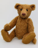 Cinnamon is an elegant and charming, one of a kind, traditional artist teddy bear by Barbara Ann Bears, he stands 15.5 inches/39cm tall and is 11 inches/28 cm sitting. Cinnamon is made from fairly sparse and wiry cinnamon coloured German mohair with matching German wool-felt paw pads and he has boot buttons for eyes,