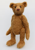 Cinnamon is an elegant and charming, one of a kind, traditional artist teddy bear by Barbara Ann Bears, he stands 15.5 inches/39cm tall and is 11 inches/28 cm sitting. Cinnamon is made from fairly sparse and wiry cinnamon coloured German mohair with matching German wool-felt paw pads and he has boot buttons for eyes,