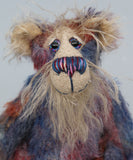 Clarence Sunbeam is mostly made from a fairly short and sparse mohair hand dyed in indigo, lilac, mauve, rose and ultramarine with splashes of rusty amber.  His face is a very long, feathery pale beige mohair and the backs of his ears and the underside of his tail are a similarly coloured shorter, twirly mohair. Clarence Sunbeam has beautiful, hand painted, glass eyes with hand coloured eyelids and carefully embroidered nose all made to incorporate the colours of his mohair and he has a beaming smile