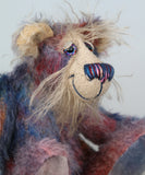 Clarence Sunbeam is mostly made from a fairly short and sparse mohair hand dyed in indigo, lilac, mauve, rose and ultramarine with splashes of rusty amber.  His face is a very long, feathery pale beige mohair and the backs of his ears and the underside of his tail are a similarly coloured shorter, twirly mohair. Clarence Sunbeam has beautiful, hand painted, glass eyes with hand coloured eyelids and carefully embroidered nose all made to incorporate the colours of his mohair and he has a beaming smile