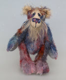 Clarence Sunbeam is a loveable and subtly coloured, one of a kind artist bear, in muted hand dyed mohair by Barbara-Ann Bears, he stands 8 inches/20 cm tall. Clarence Sunbeam is mostly made from a fairly short and sparse mohair hand dyed in indigo, lilac, mauve, rose and ultramarine with splashes of rusty amber.  His face is a very long, feathery pale beige mohair and the backs of his ears and the underside of his tail are a similarly coloured shorter, twirly mohair