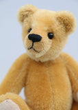 Cookie is made from dense, short, honey gold German mohair, he has black glass eyes and beige German wool felt paw pads which compliment his mohair beautifully. He has a pert, little, carefully embroidered brown nose and a gentle smile