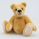 Cookie is a sweet and gentle, one of a kind, traditional artist teddy bear made from beautiful German mohair, by Barbara-Ann Bears. He stands 7 inches (18cm) tall and is 5 inches (13cm) sitting. Cookie is a sweet and charming, one of a kind, teddy bear. He's quite a traditional bear, with his beautiful blond mohair and his glass eyes, he's a gente chap a dreamer and a thinker and a dreamer. He is made from dense, short, honey gold German mohair