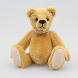 Cookie is a sweet and gentle, one of a kind, traditional artist teddy bear made from beautiful German mohair, by Barbara-Ann Bears. He stands 7 inches (18cm) tall and is 5 inches (13cm) sitting. Cookie is a sweet and charming, one of a kind, teddy bear. He's quite a traditional bear, with his beautiful blond mohair and his glass eyes, he's a gente chap a dreamer and a thinker and a dreamer. He is made from dense, short, honey gold German mohair