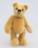 Cookie is a sweet and gentle, one of a kind, traditional artist teddy bear made from beautiful German mohair, by Barbara-Ann Bears. He stands 7 inches (18cm) tall and is 5 inches (13cm) sitting.  Cookie is a sweet and charming, one of a kind, teddy bear. He's quite a traditional bear, with his beautiful blond mohair and his glass eyes, he's a gente chap a dreamer and a thinker and a dreamer.  He is made from dense, short, honey gold German mohair