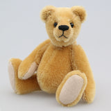 Cookie is a sweet and gentle, one of a kind, traditional artist teddy bear made from beautiful German mohair, by Barbara-Ann Bears. He stands 7 inches (18cm) tall and is 5 inches (13cm) sitting. Cookie is a sweet and charming, one of a kind, teddy bear. He's quite a traditional bear, with his beautiful blond mohair and his glass eyes, he's a gente chap a dreamer and a thinker and a dreamer. He is made from dense, short, honey gold German mohair