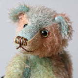Cyril is a very handsome & subtly colourful, traditional, one of a kind artist teddy bear, in hand dyed mohair by Barbara Ann Bears, he stands 8.5 inches (21 cm) tall and is 6 inches (15 cm) sitting. Cyril is made from a fairly short and sparse German mohair hand-dyed in natural hues of jade, turquoise and a soft peach