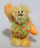 Daffy Doolittle is a very happy and colourful one of a kind, hand dyed mohair and faux fur artist bear by Barbara-Ann Bears, she is 8.5 inches/21 cm tall. Daffy Doolittle is mostly a very curly and fairly mohair that Barbara has hand dyed in beautiful shades of yellow, green, lime and orange, with colourful faux fur.