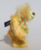 Daffy Doolittle is a very happy and colourful one of a kind, hand dyed mohair and faux fur artist bear by Barbara-Ann Bears, she is 8.5 inches/21 cm tall. Daffy Doolittle is mostly a very curly and fairly mohair that Barbara has hand dyed in beautiful shades of yellow, green, lime and orange, with colourful faux fur.