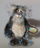 Danny Dalrymple's main mohair is a medium length, slightly wavy German mohair that has a dark brown base, the tips were then bleached and then the very ends dyed blue, so it has three colours along each thread. His tummy is a dense straight pile nearly white mohair which has a few black threads and his face, the fronts of his ears and the underside of his tail are a long fluffy white mohair tipped with blue. He has hand-dyed velvet paw pads which tie in with his mohair beautifully.