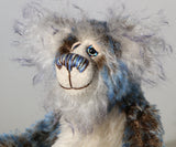 Danny Dalrymple has beautiful, hand painted eyes with eyelids, a splendid nose embroidered from individual threads to complement his colouring and he has a sweet, friendly smile. His main mohair is a slightly wavy German mohair that has a dark brown base, the tips were then bleached and then the very ends dyed blue and his face, the fronts of his ears and the underside of his tail are a long fluffy white mohair tipped with blue