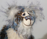 Danny Dalrymple has beautiful, hand painted eyes with eyelids, a splendid nose embroidered from individual threads to complement his colouring and he has a sweet, friendly smile. His main mohair is a slightly wavy German mohair that has a dark brown base, the tips were then bleached and then the very ends dyed blue and his face, the fronts of his ears and the underside of his tail are a long fluffy white mohair tipped with blue