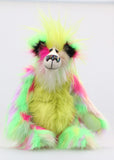 Dazzling Dave is a flamboyant fun-loving and comical, one of a kind, artist bear by Barbara-Ann Bears, he stands 13 inches/33 cm tall and is 10.5 inches/27 cm sitting. He is made of bright lime, pink, yellow and lavender faux fur, with lime paw pads, hand painted eyes, a beautiful multi coloured nose and a sweet smile