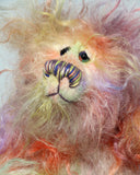 Dear Prudence, a bright and friendly, one of a kind, artist teddy bear by Barbara-Ann Bears, she stands 8.5 inches( 21 cm) tall and is 6.5 inches ( 16 cm) sitting.  Dear Prudence is made from a very long and twirly mohair that Barbara has dyed in oranges, greens, blues, reds, yellows, maroons, purples and lilacs