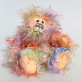 Dear Prudence, a bright and friendly, one of a kind, artist teddy bear by Barbara-Ann Bears, she stands 8.5 inches( 21 cm) tall and is 6.5 inches ( 16 cm) sitting.  Dear Prudence is made from a very long and twirly mohair that Barbara has dyed in oranges, greens, blues, reds, yellows, maroons, purples and lilacs