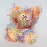 Dear Prudence, a bright and friendly, one of a kind, artist teddy bear by Barbara-Ann Bears, she stands 8.5 inches( 21 cm) tall and is 6.5 inches ( 16 cm) sitting.  Dear Prudence is made from a very long and twirly mohair that Barbara has dyed in oranges, greens, blues, reds, yellows, maroons, purples and lilacs
