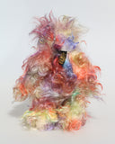 Dear Prudence, a bright and friendly, one of a kind, artist teddy bear by Barbara-Ann Bears, she stands 8.5 inches( 21 cm) tall and is 6.5 inches ( 16 cm) sitting.  Dear Prudence is made from a very long and twirly mohair that Barbara has dyed in oranges, greens, blues, reds, yellows, maroons, purples and lilacs