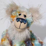 Elgar is made from a beautiful medium length mohair hand dyed in sky blue, emerald, lime, gold, amber and a greyish brown. His face, tummy, the underside of his tail and the fronts of his ears are a very long and luxuriously fluffy, pearly white mohair with a warm alabaster coloured backcloth. The velvet for Elgar's has paw pads was dyed with his mohair. Elgar has beautiful, hand painted eyes with hand coloured eyelids, a nose embroidered from individual threads to match his colouring and a gentle smile