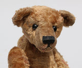 Eustace is a very lovable and sweet, one of a kind, traditional artist teddy bear made from gorgeous vintage mohair by Barbara-Ann Bears. Eustace stands 8 inches (20 cm) tall and is 6 inches (15 cm) sitting. Eustace is made from beige vintage German mohair with a faint design in red, with boot button eyes