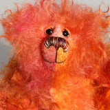 Flamin' Frizz has hand painted glass eyes with hand coloured eyelids. He has a carefully embroidered nose, sewn from individual threads to match the colouring of his mohair, and a warm beaming smile which gives him that puppy dog 'please pick me up and love me' expression