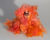 Flamin' Frizz is an adorably cute little artist bear in wildly curly hand dyed mohair by Barbara-Ann Bears, he stands 7.5 inches/19 cm tall and is 6 inches/15 cm sitting.  Flamin' Frizz is a wild and shaggy chap, he's small enough to carry around and as he loves meeting and amazing people he's a very willing companion.