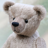 Frederick is a very sweet and cuddly, traditional teddy bear by Barbara Ann Bears, he stands 15.5 inches (39cm) tall and is 11.5 inches (29cm) sitting. Frederick is made from a silvery-grey German mohair with a straight, fairly short pile and a soft brown backing he has grey wool felt paws and vintage boot buttons eyes