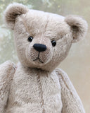 Frederick is a very sweet and cuddly, traditional teddy bear by Barbara Ann Bears, he stands 15.5 inches (39cm) tall and is 11.5 inches (29cm) sitting. Frederick is made from a silvery-grey German mohair with a straight, fairly short pile and a soft brown backing he has grey wool felt paws and vintage boot buttons eyes