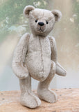 Frederick is a very sweet and cuddly, traditional teddy bear by Barbara Ann Bears, he stands 15.5 inches (39cm) tall and is 11.5 inches (29cm) sitting. Frederick is made from a silvery-grey German mohair with a straight, fairly short pile and a soft brown backing he has grey wool felt paws and vintage boot buttons eyes