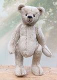 Frederick is a very sweet and cuddly, traditional teddy bear by Barbara Ann Bears, he stands 15.5 inches (39cm) tall and is 11.5 inches (29cm) sitting. Frederick is made from a silvery-grey German mohair with a straight, fairly short pile and a soft brown backing he has grey wool felt paws and vintage boot buttons eyes