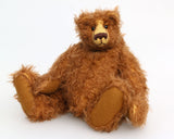 Garth is a very sweet and cuddly, artist teddy bear by Barbara Ann Bears in wonderful chocolate brown mohair, he stands 11 inches/28 cm tall and is 8.5 inches/21 cm sitting. Garth is made from a beautiful, slightly distressed brown German mohair with matching German wool-felt paw pads and small amber glass eyes