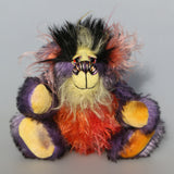 Geoffrey Sniggers is a little exceedingly happy one of a kind, mohair artist bear by Barbara-Ann Bears, he stands just 6 inches/15cm tall and is 5 inches/13 cm sitting. He's made from a black tipped violet mohair, mixed with orange and yellow hand dyed mohair and black faux fur on his head with long plumes of colour