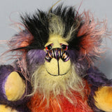 Geoffrey Sniggers has beautiful, hand painted eyes with eyelids, a splendid nose embroidered from individual threads to compliment his colouring and he has a sweet, friendly smileand on top of his head,  Geoffrey has a fairly long and dense black faux fur from which plumes of very long orange, violet, magenta and yellow faux fur emerge, a bit like fireworks