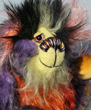 Geoffrey Sniggers has beautiful, hand painted eyes with eyelids, a splendid nose embroidered from individual threads to compliment his colouring and he has a sweet, friendly smileand on top of his head, Geoffrey has a fairly long and dense black faux fur from which plumes of very long orange, violet, magenta and yellow faux fur emerge, a bit like fireworks