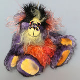 Geoffrey Sniggers is a little exceedingly happy one of a kind, mohair artist bear by Barbara-Ann Bears, he stands just 6 inches/15cm tall and is 5 inches/13 cm sitting. He's made from a black tipped violet mohair, mixed with orange and yellow hand dyed mohair and black faux fur on his head with long plumes of colour