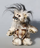 Great Scott is a little, endearingly sweet one of a kind, artist bear by Barbara-Ann Bears in fluffy mohair and wonderful faux fur. He stands just 6 inches/15 cm tall and is 5 inches/18 cm sitting. He is made from dense spotty faux fur with long black plumes of faux fur around his head and a little spotty pink tail.